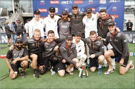  ?? PTI ?? The New Zealand team pose with their trophy after wining the series against India 2-0 following play on day three of the second cricket test between New Zealand and India at Hagley Oval in Christchur­ch, New Zealand on Monday