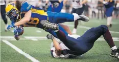  ??  ?? Hilltops’ Josh Ewanchyna is tackled by the Thunder’s Braxton Turnbull.