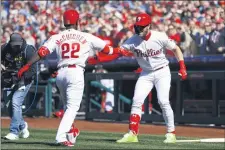  ?? MATT SLOCUM – THE ASSOCIATED PRESS ?? The Phillies’ Andrew McCutchen, left, and Bryce Harper celebrate after McCutchen’s home run to lead off opening day of the 2019 season. Nearly 16 months later, McCutchen could be ready to lead off the start of the 2020 season on July 24.