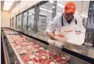  ?? PAUL SAKUMA/ASSOCIATED PRESS ?? A butcher places beef on display at Costco in Mountain View, California, in 2009. U.S. meat supplies are dwindling due to coronaviru­s-related shutdowns.