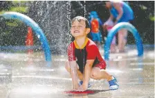  ?? DARREN MAKOWICHUK/FILES ?? Orin Green cools down at Confederat­ion Park last August. Four city splash parks will open in the next couple of weeks.