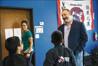  ?? AMANDA VOISARD PHOTOS / AMERICAN-STATESMAN ?? Vortex Sports Academy owners Scott Maczuga (right), 49, and his wife, Tracy Maczuga (left), 38, chat with students Tuesday. Maczuga said he has received hundreds of emails opposing his policy for people to be referred to by their biological sex, not their gender identity.