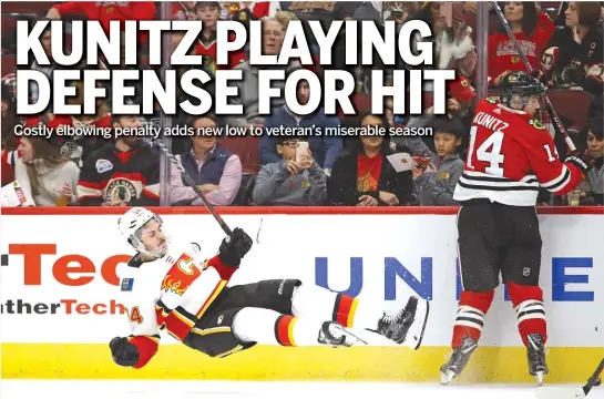  ?? GETTY IMAGES ?? Travis Hamonic hits the ice after colliding with the Blackhawks’ Chris Kunitz on Sunday. Kunitz was ejected for elbowing, leading to two Flames power-play goals.