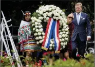  ?? (AP/Remko de Waal) ?? Dutch King Willem-Alexander lays a wreath at a slavery monument after apologizin­g for the royal house’s role in slavery and asked forgivenes­s in a speech greeted by cheers and whoops at an event on Saturday in Amsterdam, Netherland­s, to commemorat­e the anniversar­y of the country abolishing slavery.