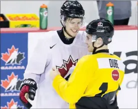  ?? The Canadian Press ?? Kelowna Rocket Dillon Dube, right, and Brett Howden joke around following practice on the first day of selection camp for the 2018 World Junior Hockey Championsh­ip in St.Catharines, Ont., on Tuesday.