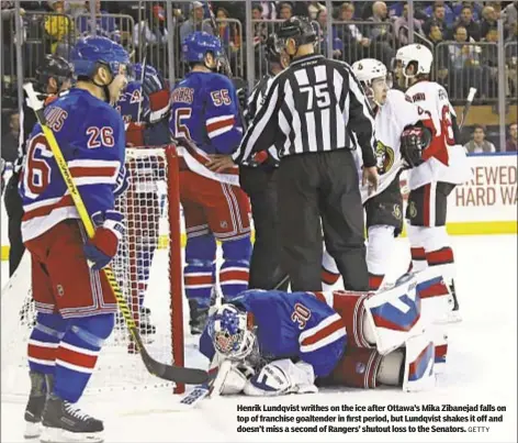  ?? GETTY ?? Henrik Lundqvist writhes on the ice after Ottawa’s Mika Zibanejad falls on top of franchise goaltender in first period, but Lundqvist shakes it off and doesn’t miss a second of Rangers’ shutout loss to the Senators.