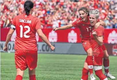  ?? BARRY GRAY/THE HAMILTON SPECTATOR ?? Canada’s Jessie Fleming, centre, celebrates a go-ahead goal with teammates Christine Sinclair, left, and Sophie Schmidt. The Canadians didn’t hold the lead for long, with the Germans scoring the equalizer a minute later.