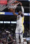  ?? ?? The Warriors' Jonathan Kuminga dunks over Mavericks forward Justin Holiday during Wednesday night's win. Kuminga had 22 points off the bench.