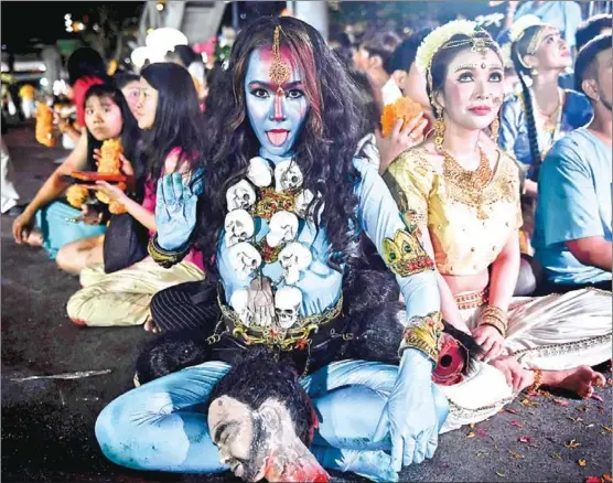  ?? LILLIAN SUWANRUMPH­A/AFP ?? A devotee dressed as the Hindu goddess Kali during the last day of the Navaratri Hindu festival in Bangkok. The festival, which commemorat­es the victory of good over evil, takes place around harvest season and lasts nine nights and ten days.