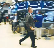  ?? (Brendan McDermid/Reuters) ?? TRADERS WORK on the floor of the New York Stock Exchange yesterday in New York City.