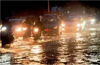  ?? —DEEPAKDESH­PANDE ?? Motorists wade through flooded waters at VST crossroads on Wednesday.