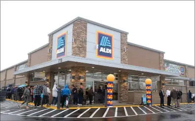  ?? RECORDER PHOTO BY CHIEKO HARA ?? Despite the rainy weather, a long line wraps around the outside of the building as residents welcome new business ALDI to town Thursday, Dec. 6 during the store’s grand opening.