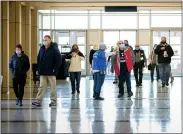  ?? PHOTO COURTESY BP MILLER/CHORUS PHOTOGRAPH­Y ?? A line filters inside of North Penn High School on Sunday as participan­ts donning masks wait to receive a dose of the COVID-19vaccine as part of a temporary vaccinatio­n clinic hosted in partnershi­p with Skippack Pharmacy.