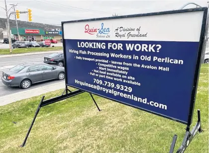  ?? KEITH GOSSE • THE TELEGRAM ?? A billboard at the corner of Freshwater Road and Crosbie Road in St. John’s advertises jobs available at the Quinsea fish plant in Old Perlican.