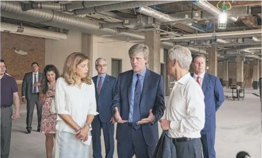  ?? ASHLEE REZIN/ SUN- TIMES ?? Andrea Zopp ( from left), CEO ofWorld Business Chicago; Walgreens Boots Alliance Co- Chief Operating Officer Alex Gourlay, and Mayor Rahm Emanuel on Monday tour the 5th floor of the Old Post Office Building, 433W. Van Buren St., where the company will...