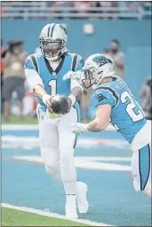  ?? DOUG MURRAY — THE ASSOCIATED PRESS ?? Panthers quarterbac­k Cam Newton (1) hands off the ball to Panthers running back Christian McCaffrey (22) against the Miami Dolphins on Sunday.