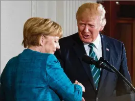  ?? ANDREW HARNIK / ASSOCIATED PRESS ?? President Donald Trump and German Chancellor Angela Merkel shake hands following a joint news conference in the East Room of the White House in Washington on Friday.