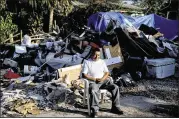  ?? NEW YORK TIMES ?? Ernestino Leon sits among the debris removed from his family’s flood-damaged home in Bonita Springs, Fla., Oct. 11. Five weeks after asking FEMA for help, the Leons moved into a hotel, while waiting for the agency to provide funds to fix their home.