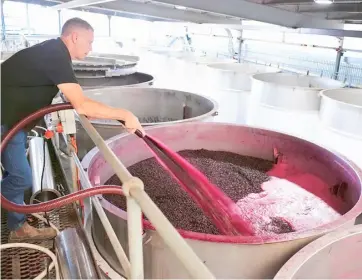 ?? ZHANG JIANHUA/XINHUA ?? Barrel stacking season Kym Teusner, a winery owner, works at his winery in Barossa Valley in South Australia. The grape harvest season has started in South Australia, a major wine making region in Australia.