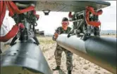  ?? PROVIDED TO CHINA DAILY ?? A soldier checks the weaponry on an attack helicopter on Wednesday.