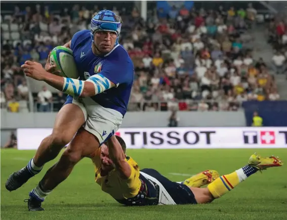  ?? ?? Italy's Gianmarco Lucchesi, left, is tackled by Romania's Gabriel Rupanu during a test rugby match between Romania and Italy at the Arcul de Triumf stadium in Bucharest, Romania, Friday, July 1, 2022. (AP Photo/Andreea Alexandru)