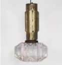  ??  ?? The “glam torch” pendant light is made of brass and glass.