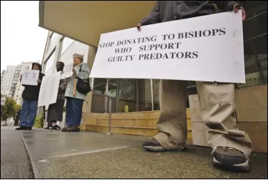  ?? ASSOCIATED PRESS FILES ?? Members of SNAP (the Survivors Network of those Abused by Priests) hold up signs during a 2019 demonstrat­ion in front of the archdioces­e headquarte­rs in San Francisco. San Francisco’s Roman Catholic archdioces­e filed for bankruptcy Monday, saying the filing is necessary to manage more than 500 lawsuits alleging child sexual abuse by church officials.