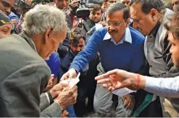  ?? — PTI ?? Chief minister Arvind Kejriwal handovers compensati­on cheques to family members of the victims of last week’s fire at a Bawana cracker factory in New Delhi on Wednesday.