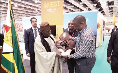  ?? — Picture by Sydney Kawadza ?? Zimtrade chief executive Mr Allan Majuru (right) hands over a sculpture to former Nigerian president Olusegun Obasanjo who paid a visit to the Zimbabwe Pavilion during the ongoing Intra-African Trade Fair at the Egypt Internatio­nal Exhibition Centre in Cairo yesterday.