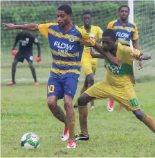  ?? PHOTO BY ASHLEY ANGUIN ?? Rusea’s High’s Nazime Matalie (left) shields the ball from Knockalva High’s Rushean Henderson during their ISSA/FLOW daCosta Cup match at Rusea’s High School on Wednesday.