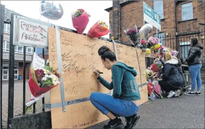  ??  ?? GREATEST SYMPATHY: Floral tributes are left outside Eastbank Academy, Glasgow, where Jodie Muir was a pupil, by her many friends. Picture: Nick Ponty