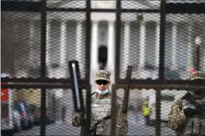  ?? The Associated Press ?? Members of the National Guard stand inside security fencing at the Capitol on Sunday in Washington, D.C.
