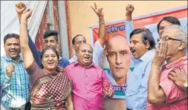  ?? AP PHOTO ?? Friends and wellwisher­s of former Indian naval officer Kulbhushan Jadhav celebrate the ICJ order as they gather near a portrait of him in Mumbai on Thursday.