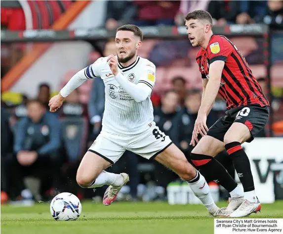  ?? ?? Swansea City’s Matt Grimes holds off Ryan Christie of Bournemout­h
Picture: Huw Evans Agency