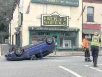  ??  ?? ●●The car on its roof in London Road, Hazel Grove