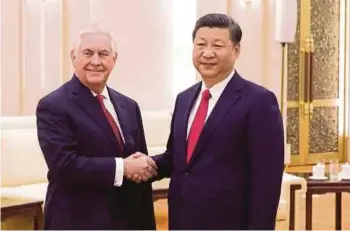  ?? AP PIC ?? Chinese President Xi Jinping with US Secretary of State Rex Tillerson at the Great Hall of the People in Beijing yesterday. Tillerson told Xi that ‘China-US relations can only be friendly’.