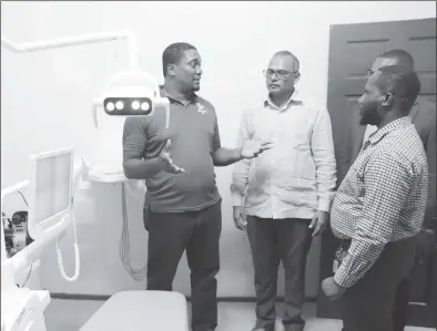  ?? ?? Inside the dental unit. Health Minister Dr Frank Anthony is second from left (Ministry of Health photo)