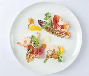  ??  ?? Chef Lukas Gurtner’s spot prawn dish features grilled endive, watercress and crispy shallots with confit citrus vinaigrett­e.