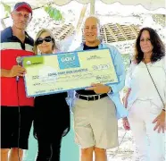  ?? CONTRIBUTE­D ?? From left: Glenn Lawrence, CEO of Couples Resorts; Maureen Sheridan, director of Animal House; Paul Issa, deputy chairman of Couples Resorts and Alex Ghisays, Group PR Director of Couples, pose with the ceremonial cheque following the resorts Charity Golf Tournament in Ocho Rios.