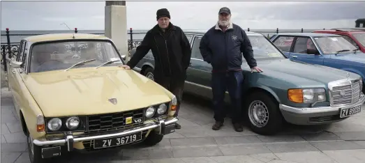  ??  ?? Jim Moore with his 1972 Rover P6 and Colin Balfe with his Mercedes 380SEL at the Bray Vintage Car Club display on Bray Seafront.