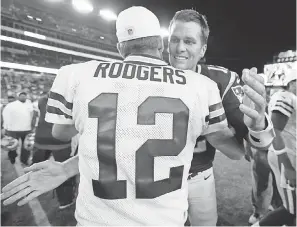  ?? MICHAEL DWYER/AP ?? Aaron Rodgers and Tom Brady will square off for the second time Sunday.