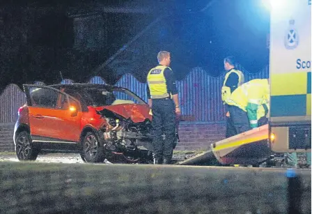  ??  ?? One of the vehicles damaged in the crash on Arbroath Road with police and an ambulance in attendance.