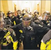  ?? Kent Nishimura Los Angeles Times ?? RIOT POLICE clear a Capitol hallway Jan. 6. Those in charge of security said in Tuesday’s Senate hearing that they lacked intelligen­ce on a possible attack.