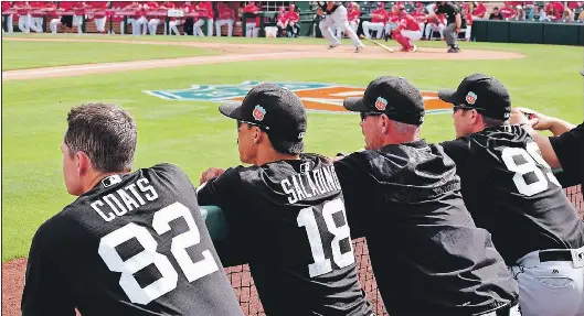  ?? STEVE MACNAULL PHOTO ?? Members of the Chicago White Sox watch from the dugout in a spring training game against the Los Angeles Angels in Tempe, Arizona.