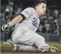  ?? Robert Gauthier Los Angeles Times ?? COREY SEAGER slides safely into third base during a division series game against Arizona on Oct. 6. Seager hurt his back on a slide in the final game of the series on Oct. 9.