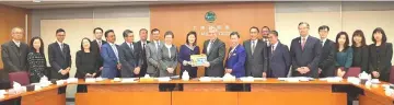  ??  ?? Awang Tengah (front, ninth right) receives a memento from Hong Kong Land Registrar, Doris Cheung. Also seen are (from Awang Tengah’s left) Dr Sim, Len Talif and Dr Annuar.