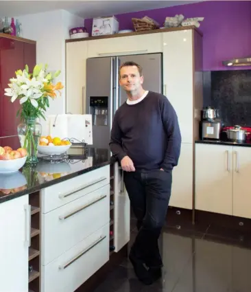  ??  ?? Left The TV room in Aengus Mac Grianna’s house is complete with comfy seating and surround sound, so is perfect for watching movies Above Aengus in the kitchen with its purple units and black granite worktops. He loves to cook for himself, his husband,...