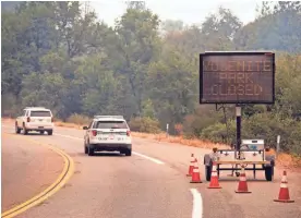  ?? NOAH BERGER/AP ?? A sign on Highway 41 announces the closure of Yosemite National Park near Oakhurst, Calif., on Wednesday. The valley could reopen Friday.