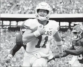  ?? RONALD MARTINEZ/GETTY ?? Sam Ehlinger smiles as he scores the first of his three rushing touchdowns for Texas.