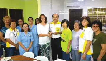  ??  ?? (From fifth right) PCAM treasurer Richard Wong receiving personal donation from Dr Mieke van de Leemput from Holland (PCAM founder) during her recent visit to the centre. Vivian is at the back row behind Dr. Mieke.